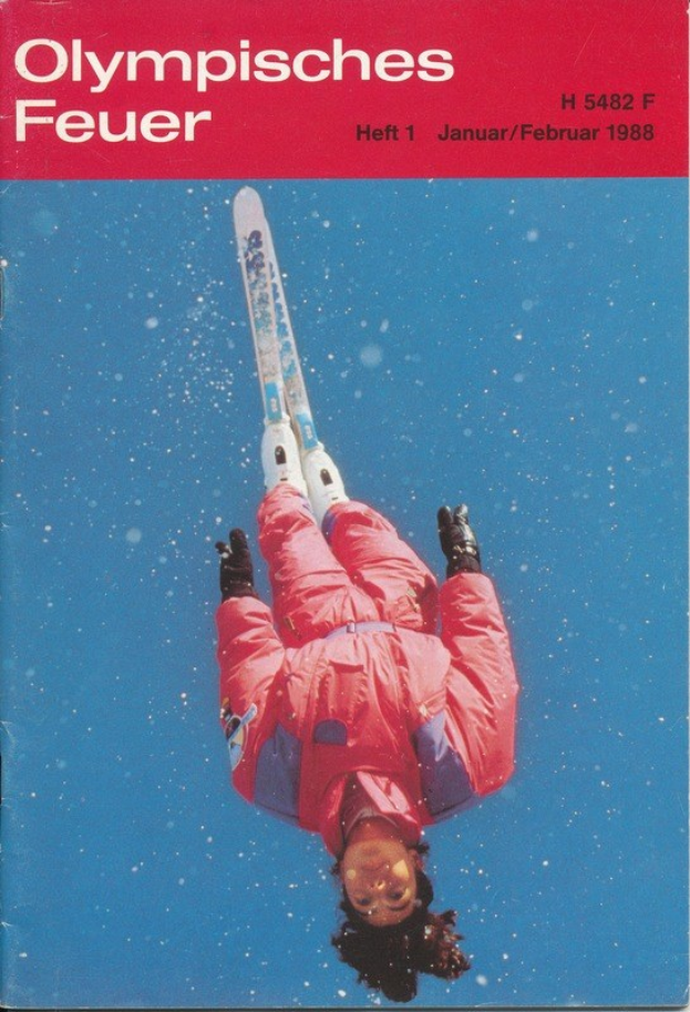Buchumschlag mit einem Skispringer in der Luft und dem Text "Olympische Spiele Feuer - Heft 1 - Januar/Februar 1988", der eine Skiuniform trägt und entschlossen wirkt.