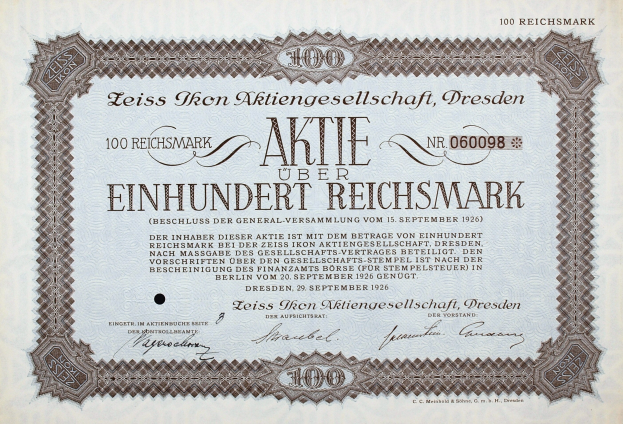 Alter deutscher Aktienchein für 100 Reichmarks mit schwarzem Rand und deutschem Text.